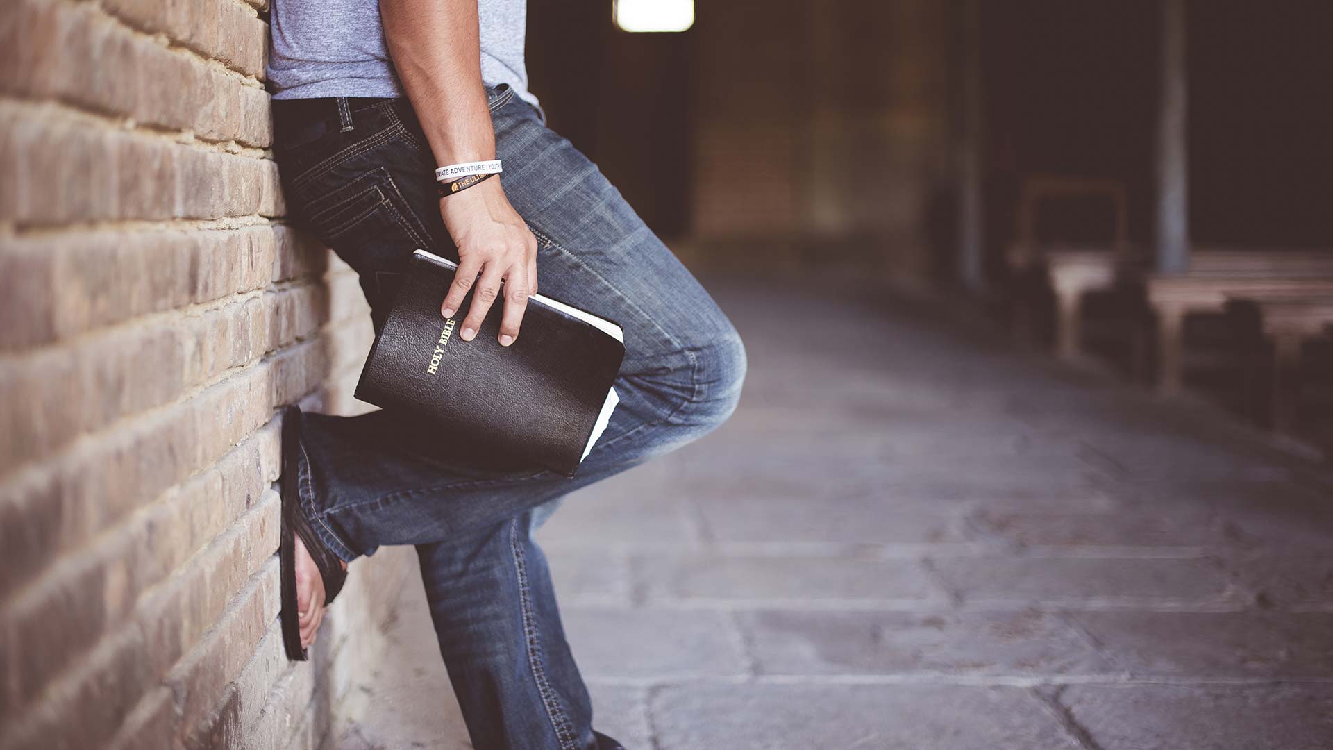Man leaning with bible